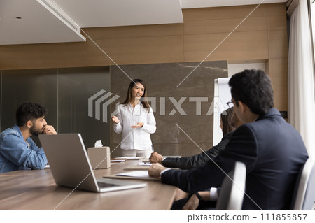 Positive Asian project manager woman presenting marketing ideas to coworkers 111855857
