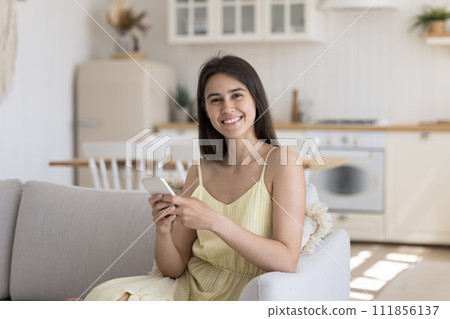 Attractive woman holding smart phone smile look at camera 111856137