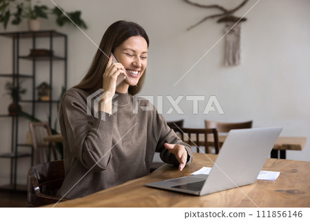 Cheerful remote professional employee woman speaking on cell 111856146