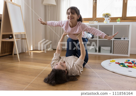 Little daughter enjoy playtime with mother in playroom 111856164
