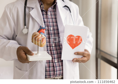 Hands of senior doctor holding greeting card with red heart 111856462