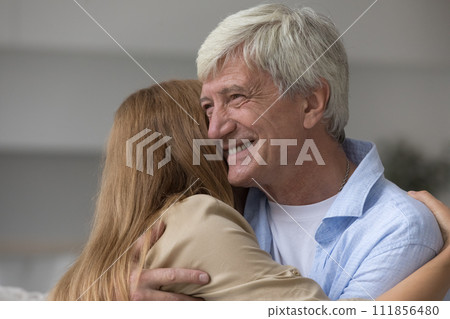 Loving daughter cuddling tightly hoary daddy, close up 111856480