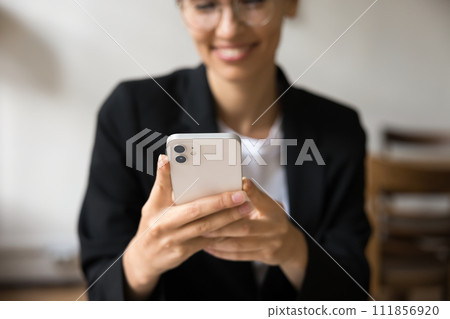 Close up of female hands holding white smartphone Close up of female hands holding white smartphone 111856920