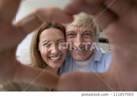 Cheerful senior dad and adult daughter child having fun Cheerful senior dad and adult daughter child having fun 111857003