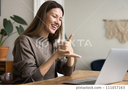 Happy communication expert speaking to patient with hearing disability online Happy communication expert speaking to patient with hearing disability online 111857163