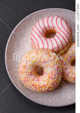 Delicious sweet bright donuts with cream on a plain background 111857165