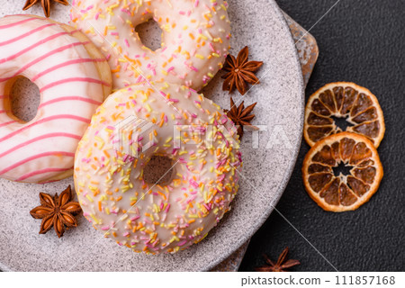 Delicious sweet bright donuts with cream on a plain background 111857168