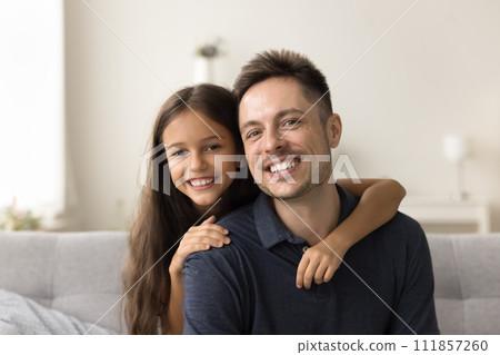 Happy handsome dad and cheerful girl looking at camera Happy handsome dad and cheerful girl looking at camera 111857260