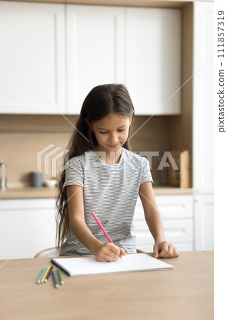 Positive pretty little kid girl drawing in colored pencils Positive pretty little kid girl drawing in colored pencils 111857319