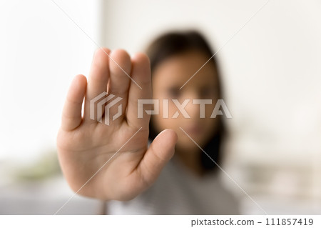 Scared kid making hand stop gesture, showing palm at camera 111857419