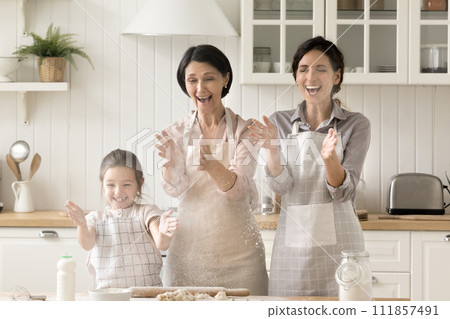 Multigenerational women family having fun while cooking in kitchen 111857491