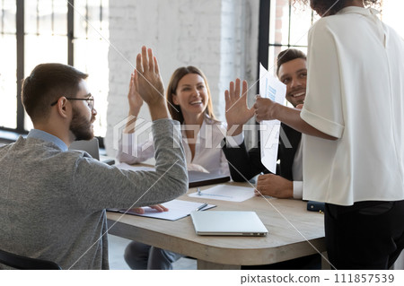 Happy employees raising hands to agree with executive 111857539