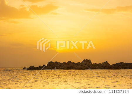 beach golden sunset sky, stone rocks background 111857554
