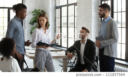 Manager and employees going over tasks during briefing 111857564