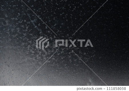 Black plastic background with gray spots Black plastic background with gray spots 111858038