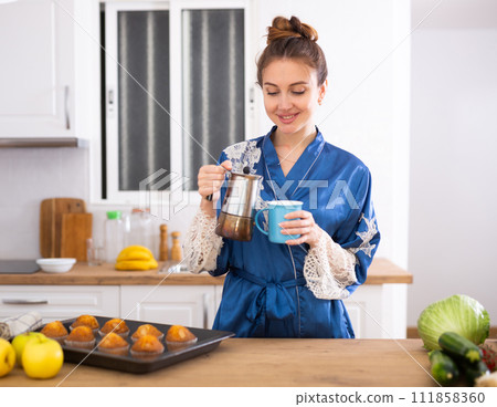 Portrait of positive woman drinking coffee at home Portrait of positive woman drinking coffee at home 111858360