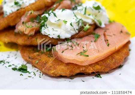 Potato pancakes with sour cream and herbs Potato pancakes with sour cream and herbs 111858474