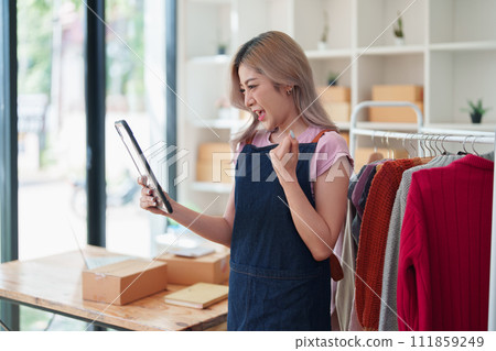 Portrait Of Asian Female Owner Of Fashion Store Clothing Store successful happy smile at small business, sme or ecommerce concepts. Portrait Of Asian Female Owner Of Fashion Store Clothing Store successful happy smile at small business, sme or ecommerce concepts. 111859249