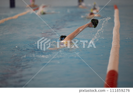 Child athlete swims in the pool. Swimming section. 111859276