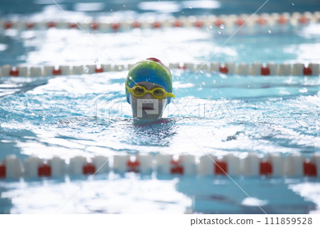 Child athlete swims in the pool. Swimming section. Child athlete swims in the pool. Swimming section. 111859528