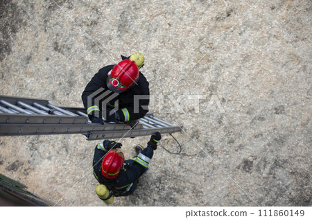 Firefighter climbs the stairs. Lifeguard training. Firefighter climbs the stairs. Lifeguard training. 111860149