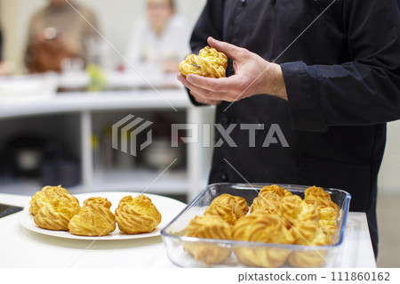 Hands cook cook eclairs. The process of making cake. Hands cook cook eclairs. The process of making cake. 111860162