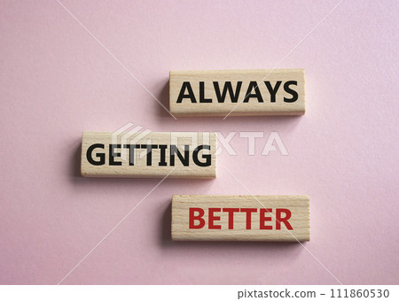 Always getting better symbol. Wooden blocks with words Always getting better. Beautiful pink background. Business and Always getting better concept. Copy space. 111860530