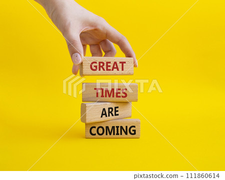 Great times are coming symbol. Concept words Great times are coming on wooden blocks. Businessman hand. Beautiful yellow background. Business and Great times are coming concept. Copy space. Great times are coming symbol. Concept words Great times are coming on wooden blocks. Businessman hand. Beautiful yellow background. Business and Great times are coming concept. Copy space. 111860614