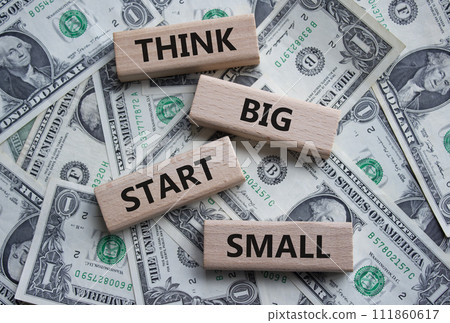 Think big start small symbol. Concept words Think big start small on wooden blocks. Beautiful dollar background. Business and Think big start small concept. Copy space 111860617