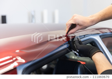 Process of gluing or wrapping a new foil wrap to a car, car detailing concept Process of gluing or wrapping a new foil wrap to a car, car detailing concept 111860670