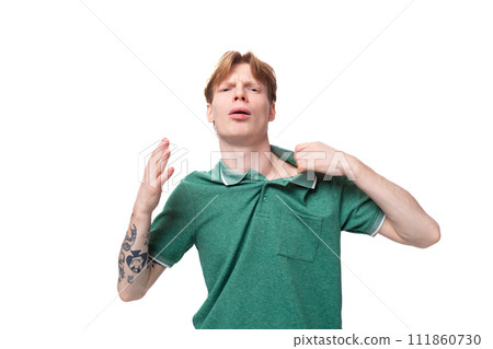 young man with red hair dressed in a green t-shirt feels confident young man with red hair dressed in a green t-shirt feels confident 111860730
