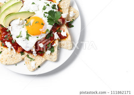 Traditional Mexican breakfast red chilaquiles with egg isolated on white background Traditional Mexican breakfast red chilaquiles with egg isolated on white background 111862171