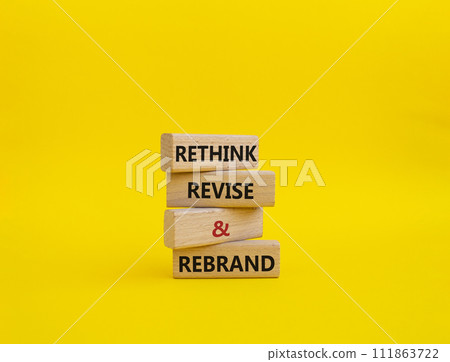 Rethink Revise and Rebrand symbol. Wooden blocks with words Rethink Revise and Rebrand. Beautiful yellow background. Business and Rethink Revise and Rebrand concept. Copy space. 111863722