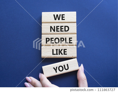 Hiring symbol. Wooden blocks with words We need People like You. Businessman hand. Beautiful deep blue background. Business and Hiring concept. Copy space. 111863727