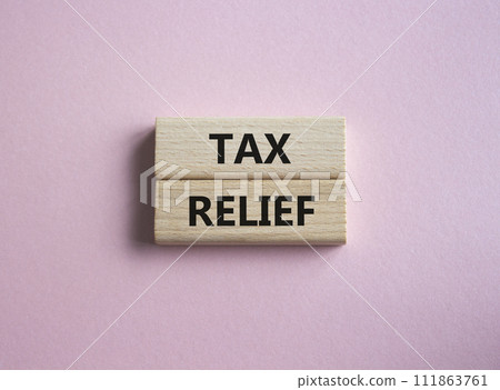 Tax Relief symbol. Concept word Tax Relief on wooden blocks. Beautiful pink background. Business and Tax Relief concept. Copy space Tax Relief symbol. Concept word Tax Relief on wooden blocks. Beautiful pink background. Business and Tax Relief concept. Copy space 111863761