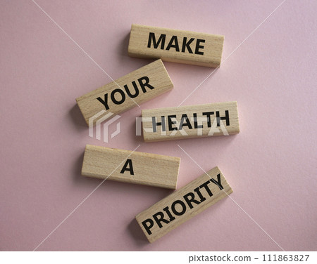 Health symbol. Wooden blocks with words Make your health a Priority. Beautiful pink background. Health concept. Copy space. 111863827