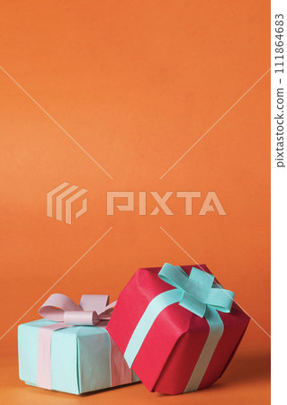 Colorful gift boxes on orange background with copy space. Colorful gift boxes on orange background with copy space. 111864683