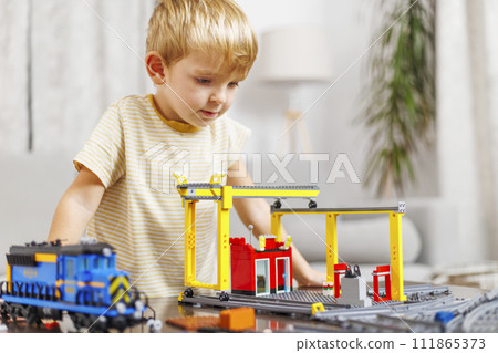 Boy Playing with Toy Train and Construction Set Boy Playing with Toy Train and Construction Set 111865373