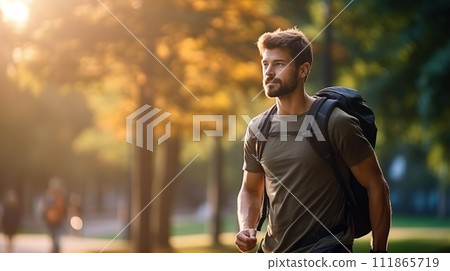 A man with a backpack enjoys nature while walking, embodying urban fitness and the trend of rucking for exercise 111865719