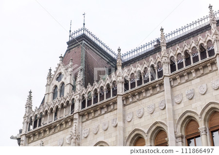 Beautiful old building of the Hungarian Parliament in neo-Gothic style Beautiful old building of the Hungarian Parliament in neo-Gothic style 111866497