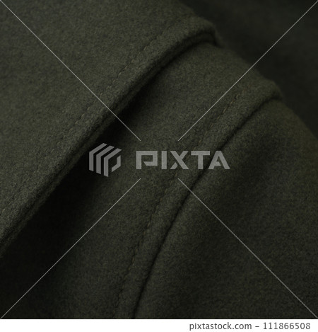 Shoulder detail of a green wool jacket 111866508