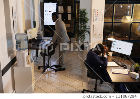 Mad entrepreneur trying to solve company investment failure, analyzing financial graph report. Upset irritated businessman working ovetime at marketing project. Business concept Mad entrepreneur trying to solve company investment failure, analyzing financial graph report. Upset irritated businessman working ovetime at marketing project. Business concept 111867294