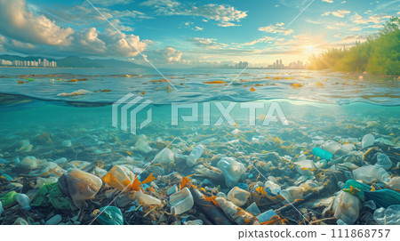 Split view of ocean and shoreline polluted with plastic debris, city skyline in the distance 111868757