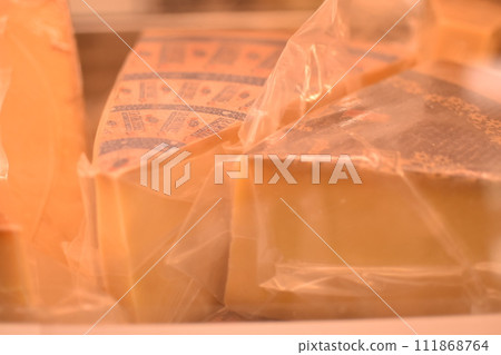 Cheeses lined up in a store Cheeses lined up in a store 111868764