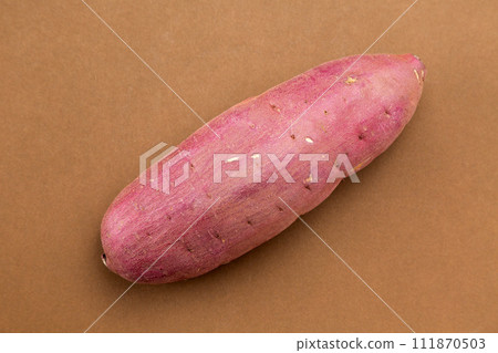 Sweet potato/silk sweet on brown background Sweet potato/silk sweet on brown background 111870503