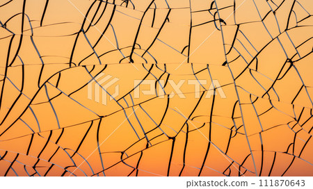 Sunset gradient through cracked glass Sunset gradient through cracked glass 111870643