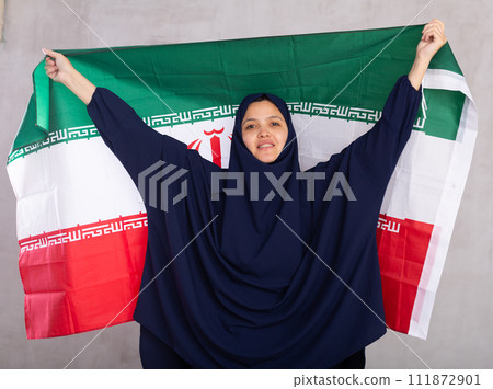 Young woman in hijab posing with Iran flag 111872901