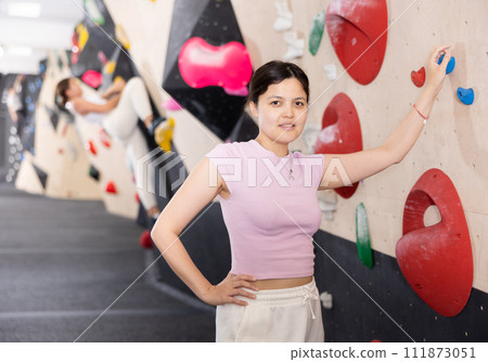 Young asian woman posing against climbing wall 111873051