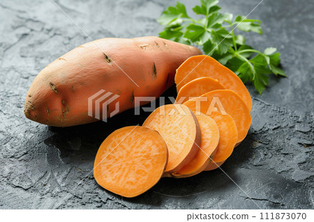 AI-generated content. Orange sweet potato slices and green parsley, raw ingredient 111873070