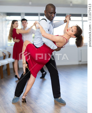Adult man and adult woman dance tango 111873413